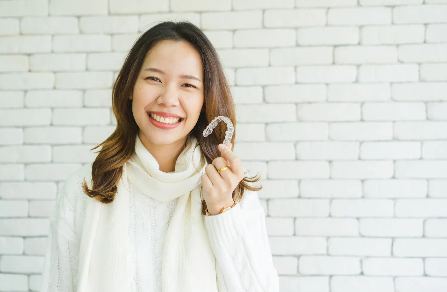 Girl holding invisalign trays